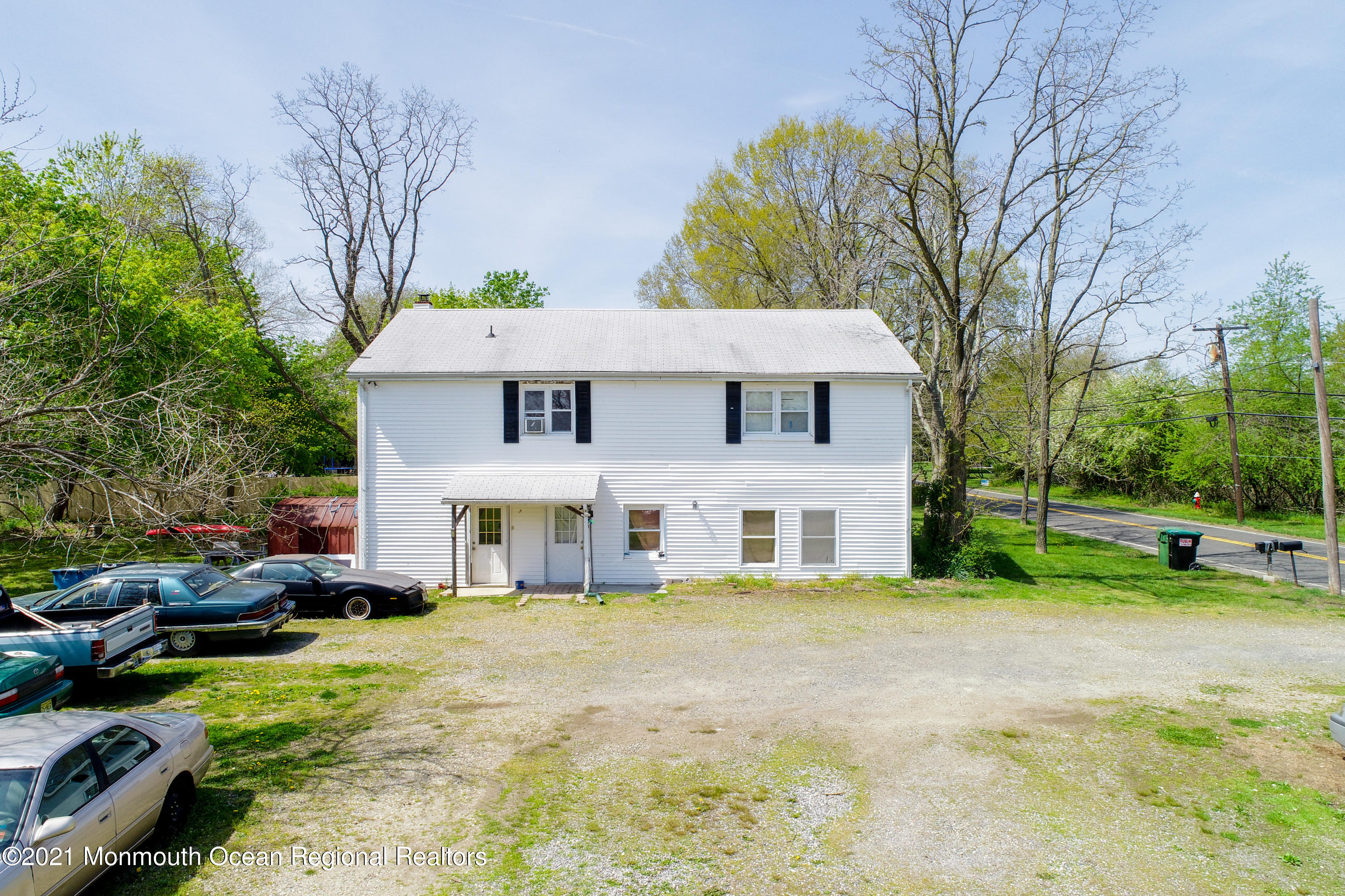 511 Squankum Yellowbrook Road Farmingdale, NJ 07727 - Photo 4 of 27 a view of a house with a big yard and large trees
