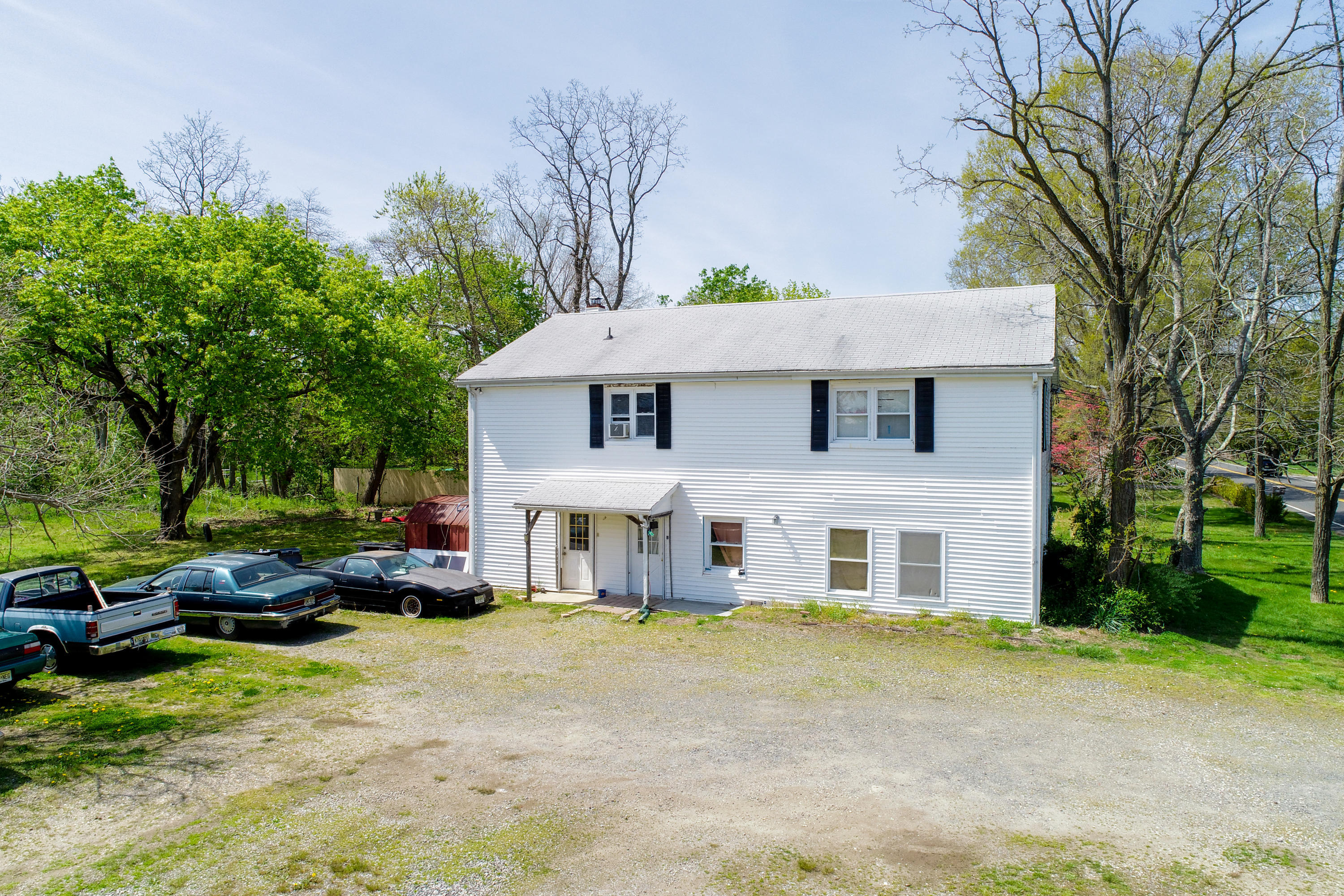 511 Squankum Yellowbrook Road Farmingdale, NJ 07727 - Photo 6 of 27 a front view of a house with a garden