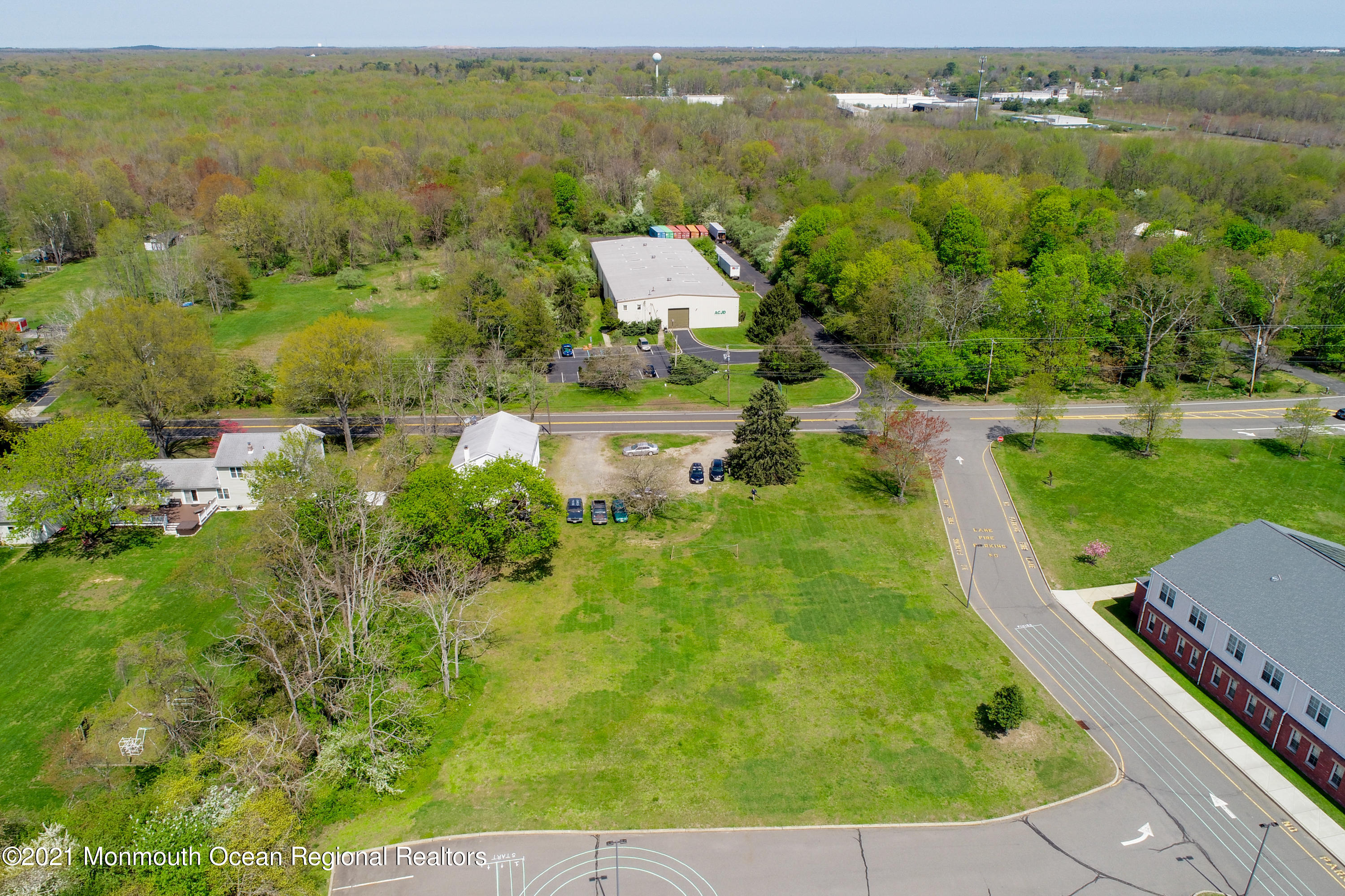511 Squankum Yellowbrook Road Farmingdale, NJ 07727 - Photo 10 of 27 an aerial view of residential houses with outdoor space and lake view