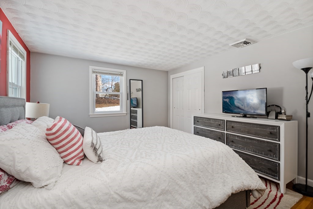 3 Athens Drive Saugus, MA 01906 - Photo 17 of 36 a bedroom with a bed and a flat screen tv