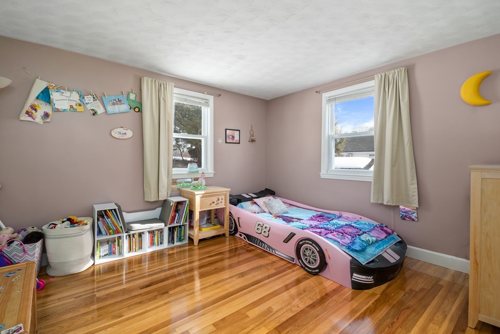 3 Athens Drive Saugus, MA 01906 - Photo 18 of 36 a bedroom with a bed and wooden floor