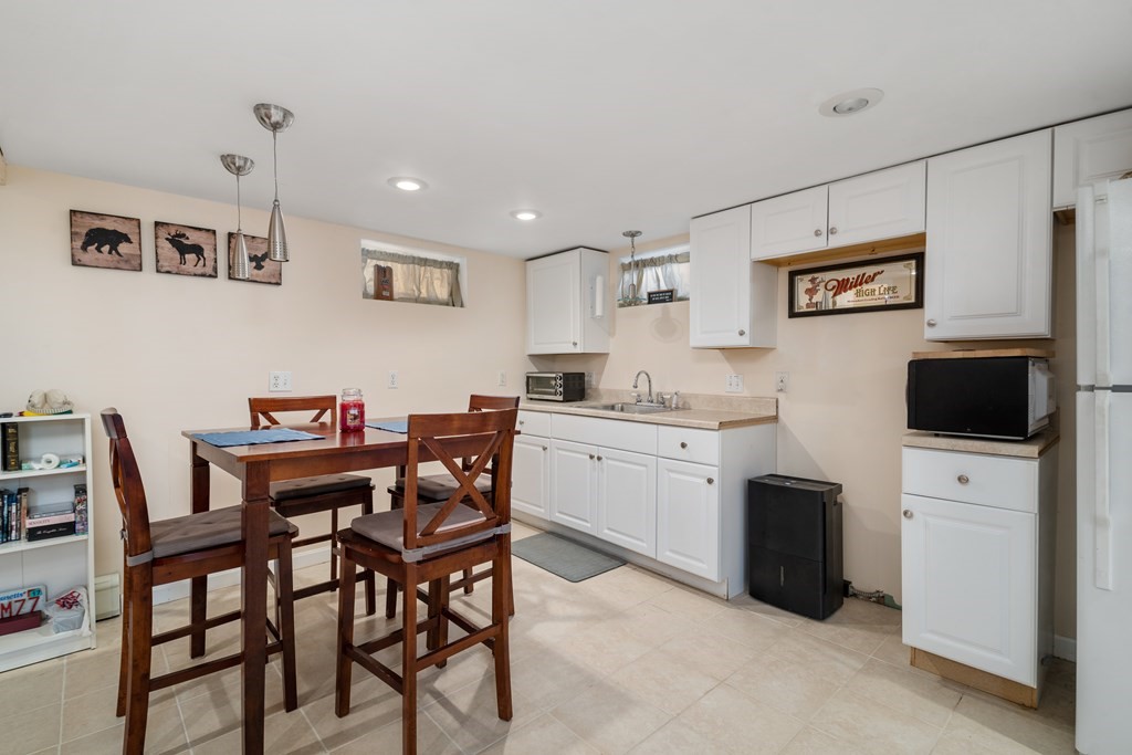 3 Athens Drive Saugus, MA 01906 - Photo 24 of 36 a kitchen that has a table and chairs in it