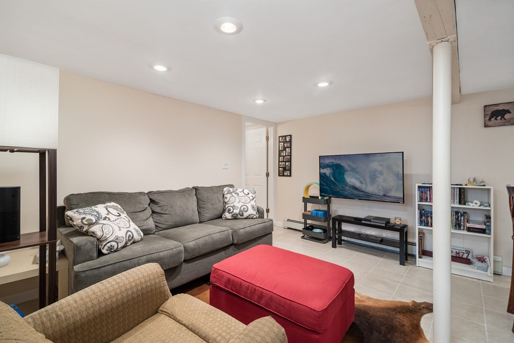 3 Athens Drive Saugus, MA 01906 - Photo 25 of 36 a living room with furniture and a flat screen tv
