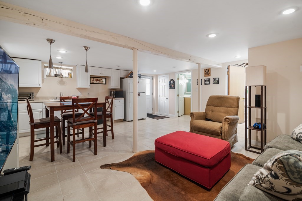3 Athens Drive Saugus, MA 01906 - Photo 26 of 36 a living room with furniture a rug and kitchen view
