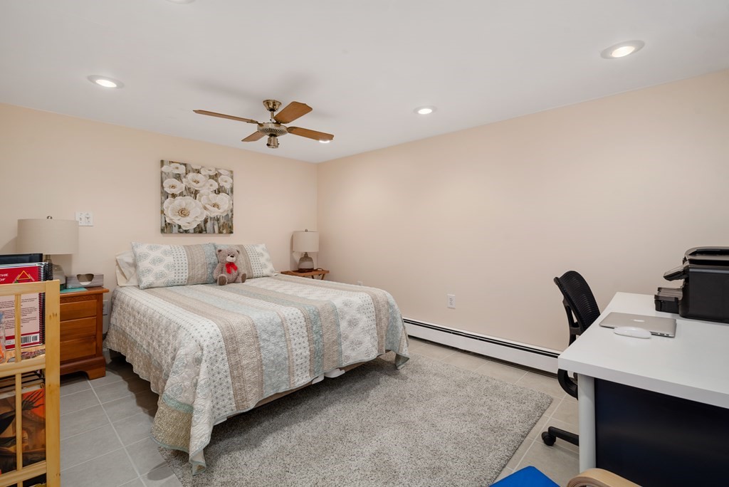 3 Athens Drive Saugus, MA 01906 - Photo 27 of 36 a bedroom with a bed and a chandelier