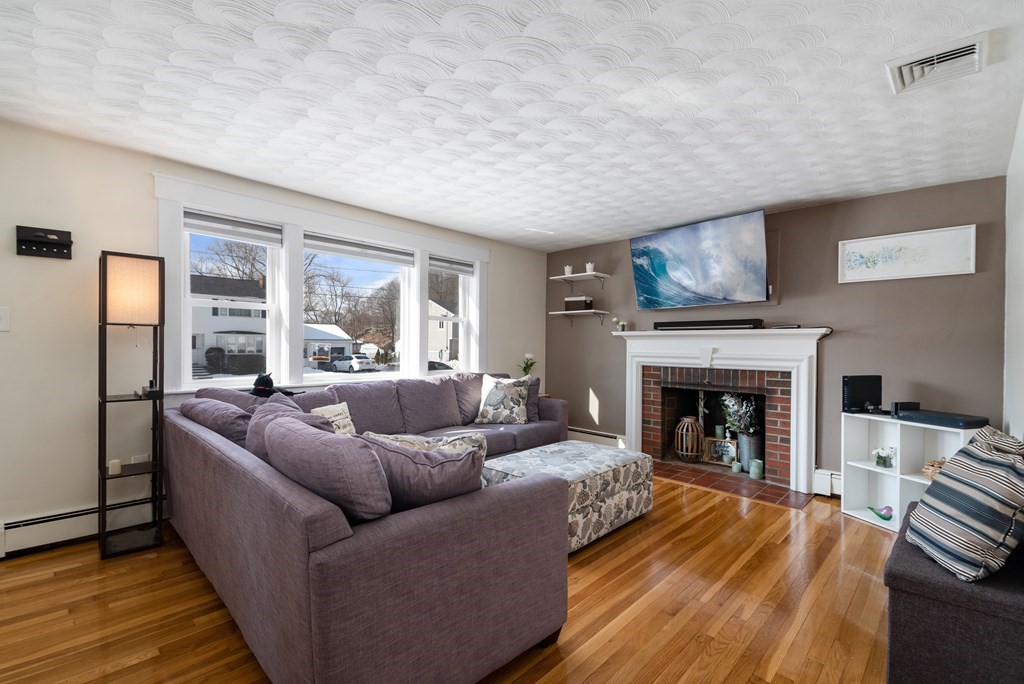 3 Athens Drive Saugus, MA 01906 - Photo 4 of 36 a living room with furniture and a fireplace