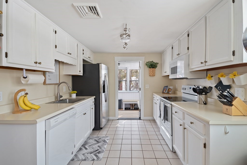 3 Athens Drive Saugus, MA 01906 - Photo 7 of 36 a kitchen with a sink stove and cabinets