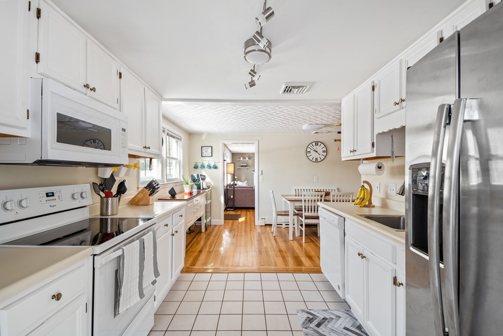 3 Athens Drive Saugus, MA 01906 - Photo 10 of 36 a large kitchen with stainless steel appliances lots of counter space and wooden floor