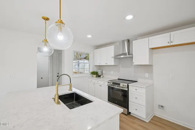 a kitchen with granite countertop white cabinets and white appliances