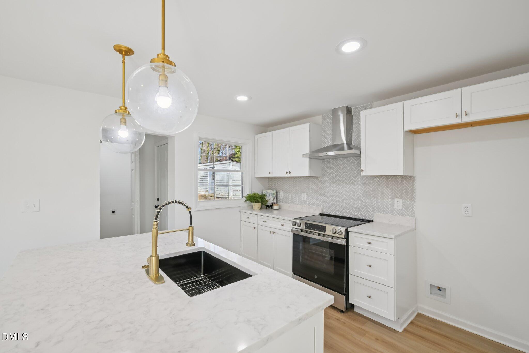 2343 Derby Drive Raleigh, NC 27610 - Photo 14 of 38 a kitchen with a sink cabinets and window