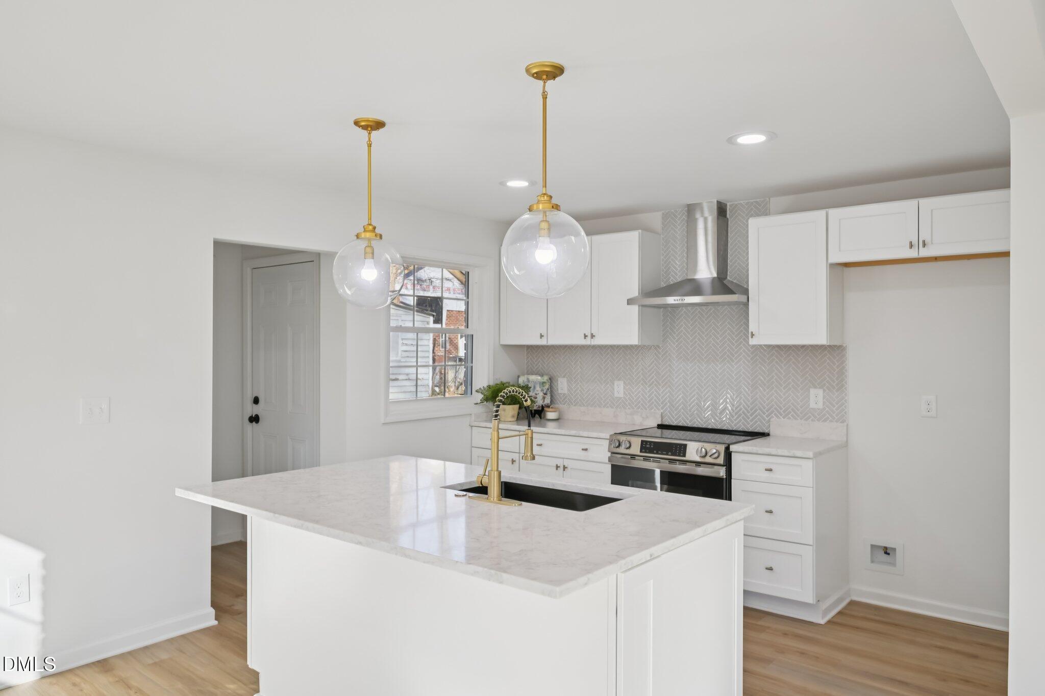 2343 Derby Drive Raleigh, NC 27610 - Photo 20 of 38 a kitchen with stainless steel appliances granite countertop a sink a refrigerator a stove a microwave and wooden floor
