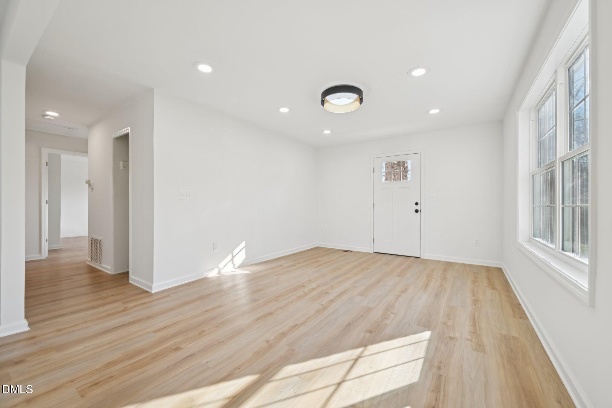 2343 Derby Drive Raleigh, NC 27610 - Photo 26 of 38 a view of an empty room with wooden floor and a window