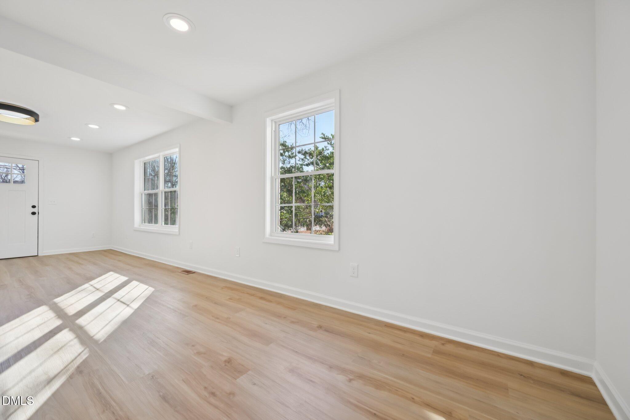 2343 Derby Drive Raleigh, NC 27610 - Photo 30 of 38 a view of an empty room with wooden floor and a window