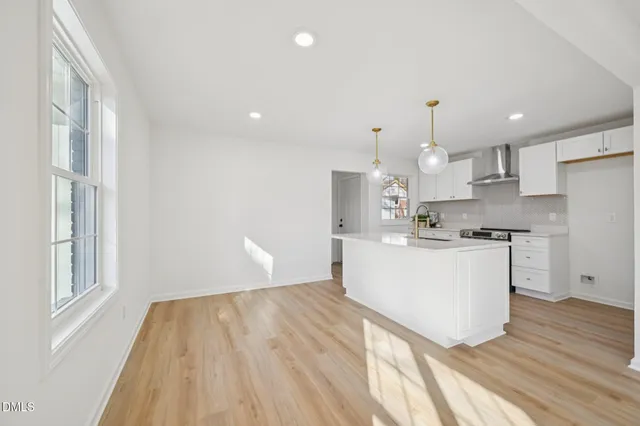 a kitchen with kitchen island a stove a sink and a refrigerator