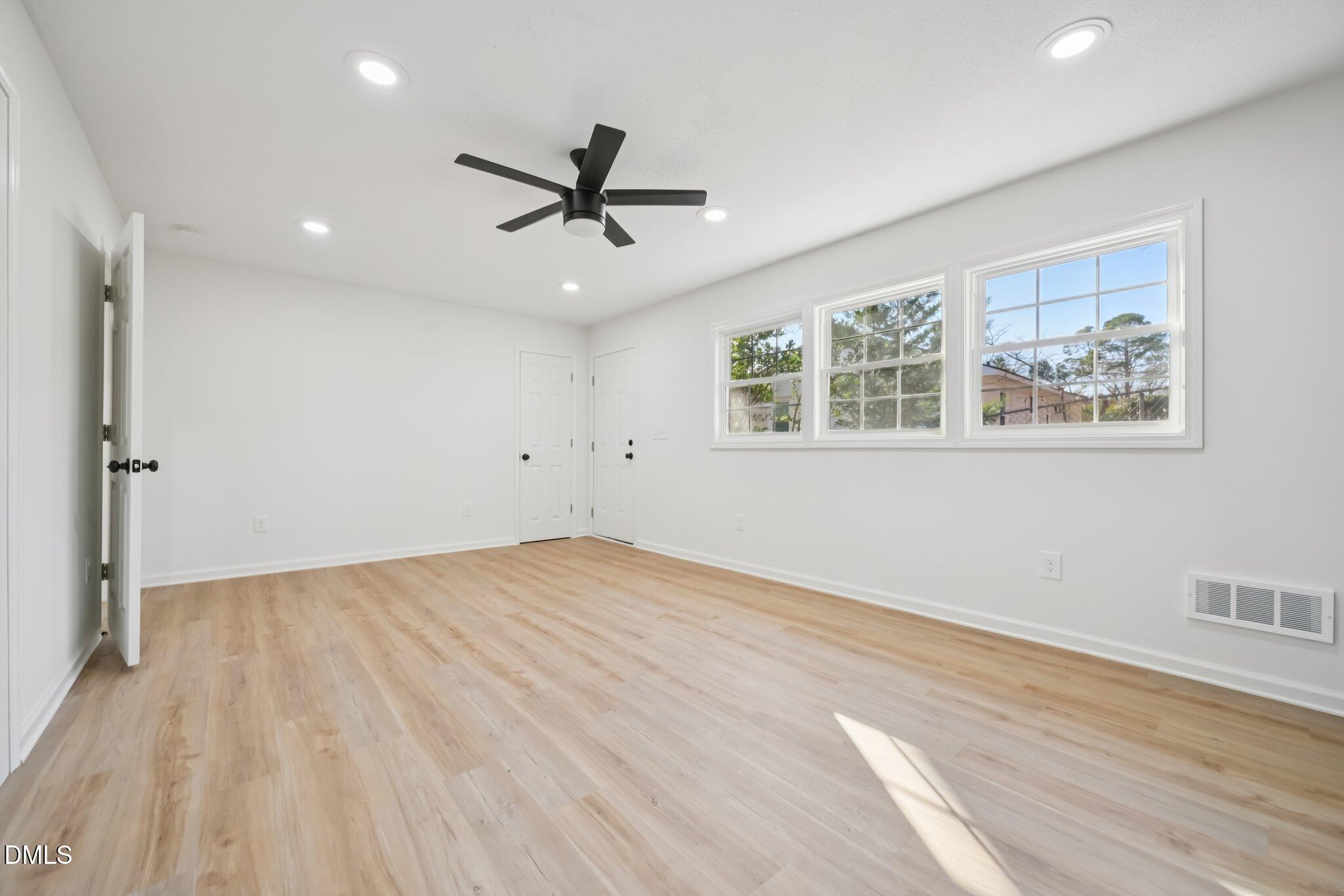 2343 Derby Drive Raleigh, NC 27610 - Photo 9 of 38 wooden floor in an empty room with a window