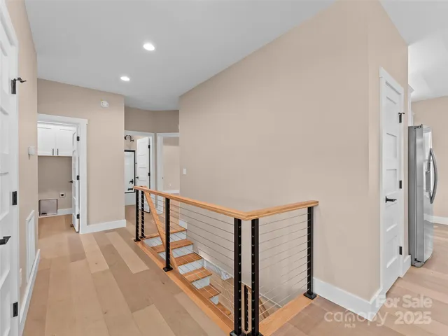 a view of a hallway with paintings on the wall
