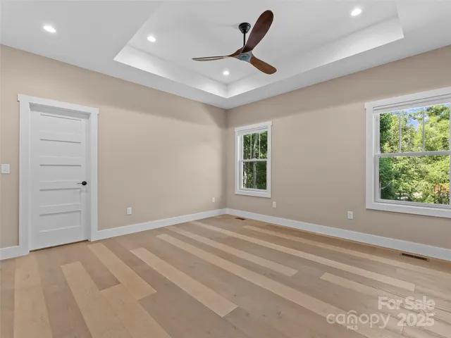 a view of a livingroom with a ceiling fan and window