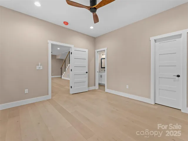 an empty room with closet and mirrors
