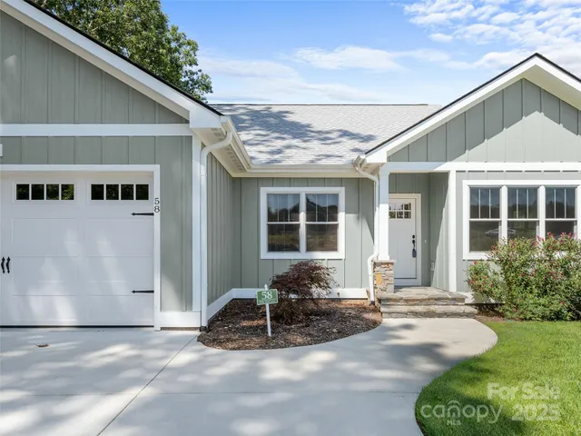 a front view of a house with garden in front of it