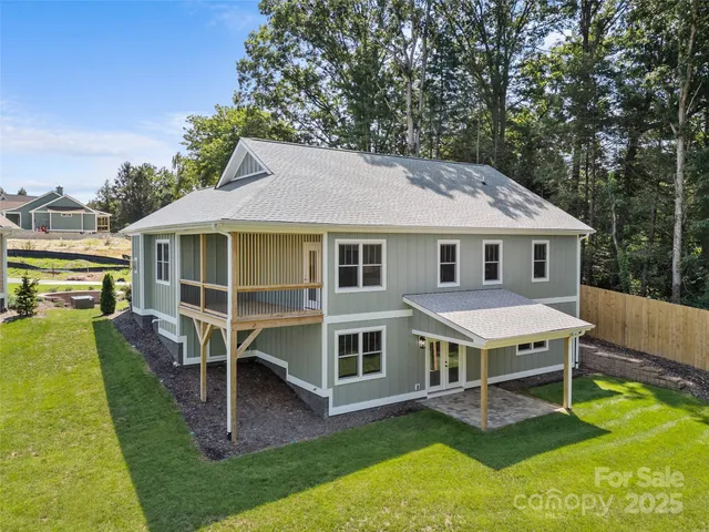 a aerial view of a house with swimming pool in front of it