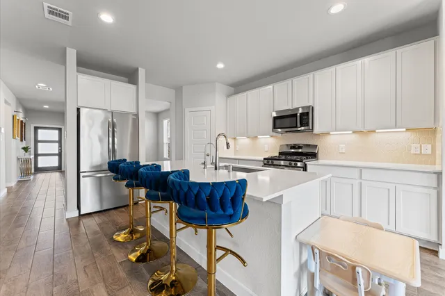 a kitchen with a sink appliances and cabinets