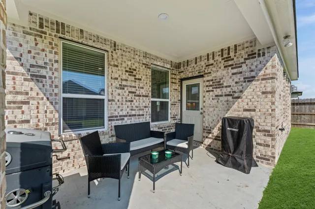 a view of a big house with a big yard and large trees