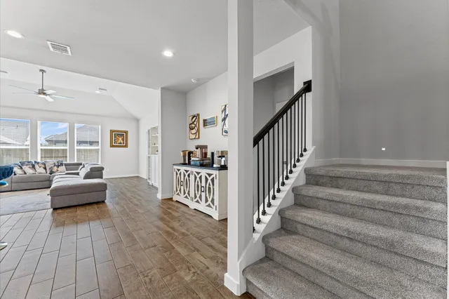 a view of a livingroom with furniture and stairs