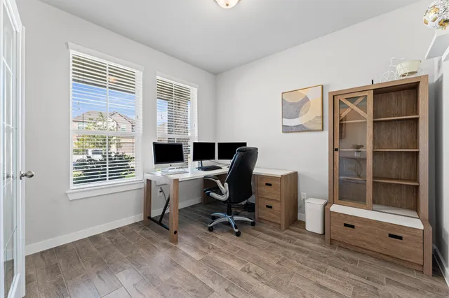 a view of a workspace with furniture and a window