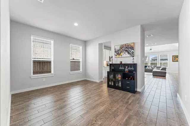 a view of a livingroom with furniture and an empty room