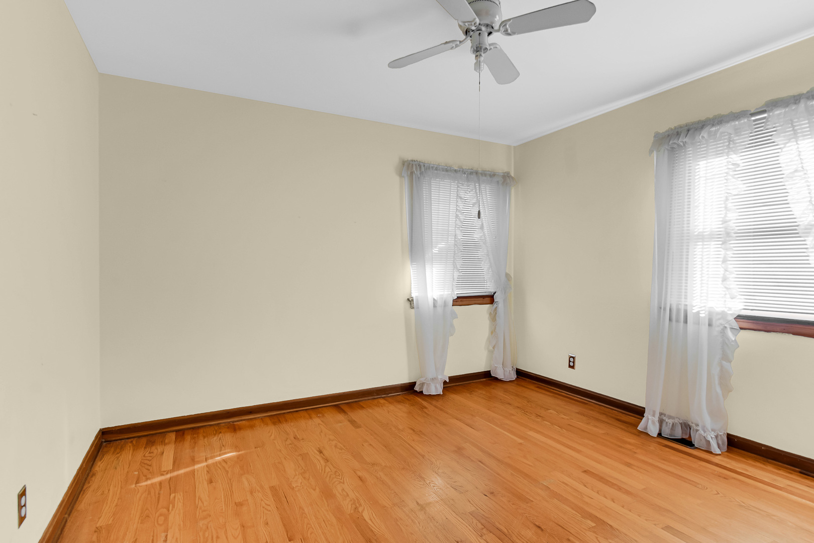 3346 Bernice Road Lansing, IL 60438 - Photo 11 of 24 a view of empty room with wooden floor and fan