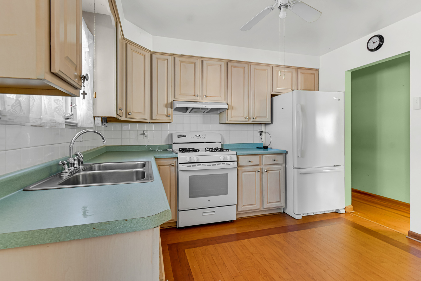 3346 Bernice Road Lansing, IL 60438 - Photo 6 of 24 a kitchen with a refrigerator sink and cabinets