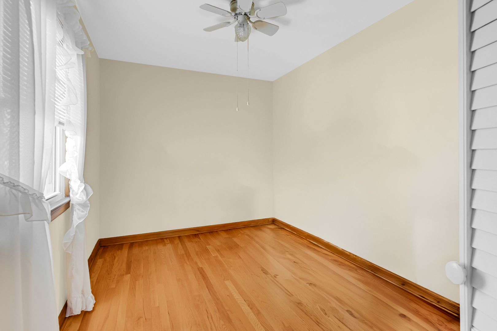3346 Bernice Road Lansing, IL 60438 - Photo 10 of 24 an empty room with a window and a ceiling fan