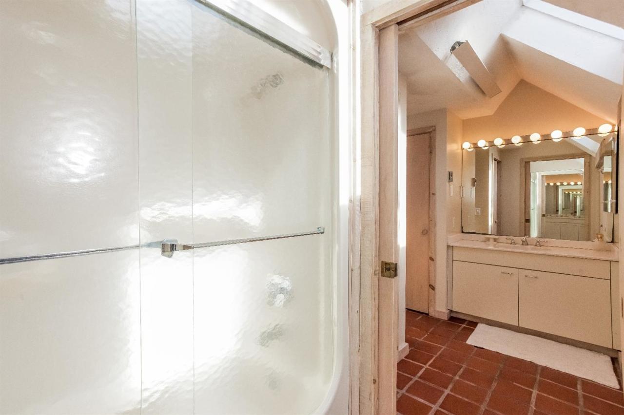 21 Metacomet Road Mashpee, MA 02649 - Photo 17 of 30 a bathroom with a glass shower door and a sink