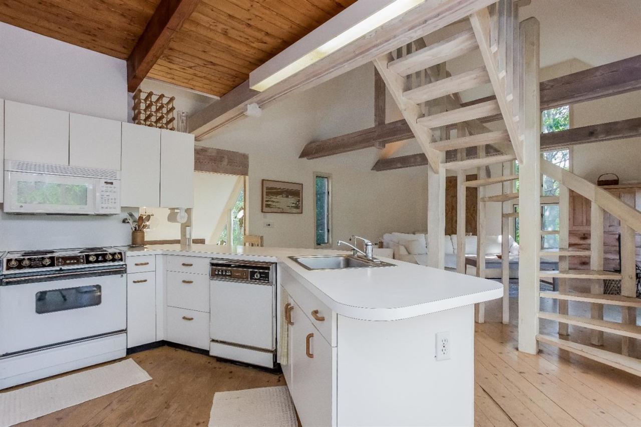 21 Metacomet Road Mashpee, MA 02649 - Photo 8 of 30 a kitchen with a sink stove and cabinets