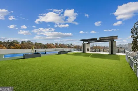 a view of a big room with pool table and a fire pit