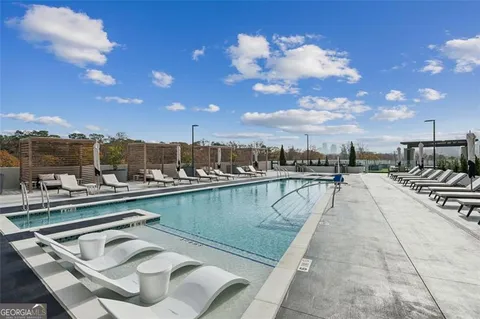 a view of a swimming pool with outdoor seating