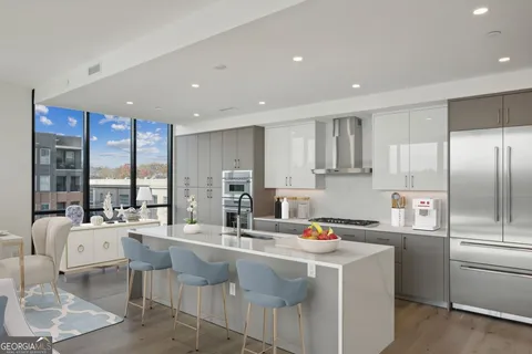 a kitchen with stainless steel appliances granite countertop a sink a stove and a refrigerator
