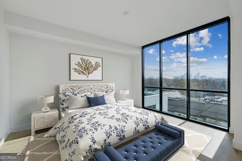 a bed sitting in a bedroom next to a window