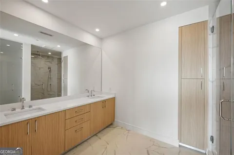 a bathroom with a double vanity sink and a mirror