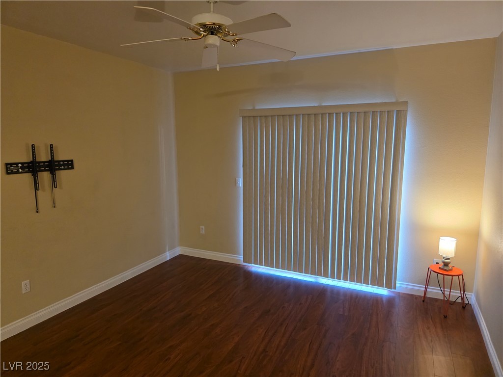 7255 West Sunset Road, Unit 1171 Las Vegas, NV 89113 - Photo 4 of 12 Empty room featuring wood finished floors, baseboards, and ceiling fan