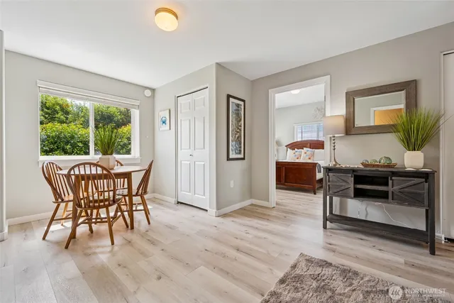 a kitchen with kitchen island granite countertop a sink stainless steel appliances and white cabinets