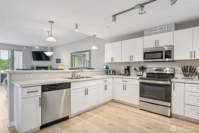 a kitchen with white cabinets and refrigerator