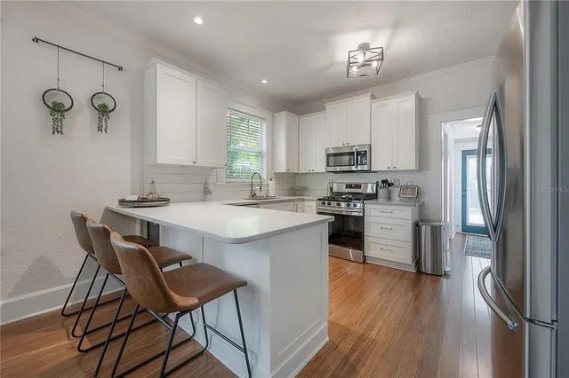 a kitchen with sink cabinets and wooden floor