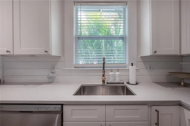 a kitchen with cabinets and wooden floor