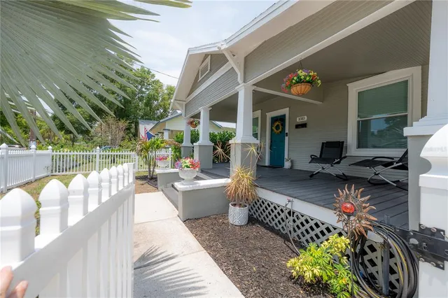 a view of a patio with couches table and chairs and potted plants