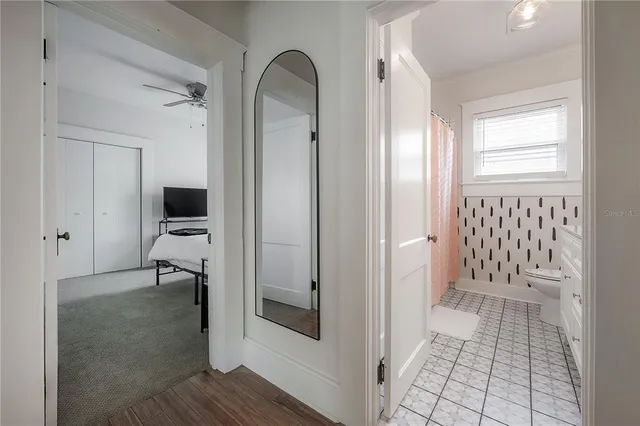 a bedroom with a bed and painting on the wall