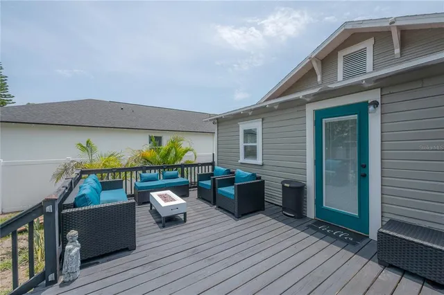 a view of a backyard with table and chairs potted plants and a barbeque