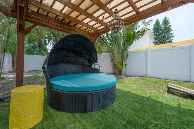 a view of a house with a yard and large tree