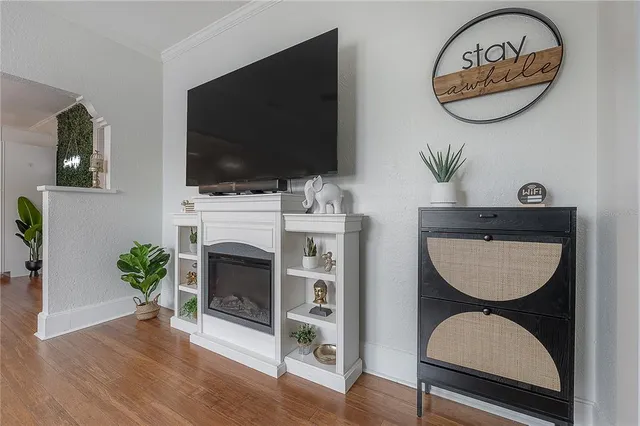 a living room with furniture a flat screen tv and a fireplace
