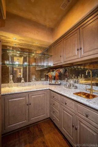 a kitchen with granite countertop a sink and cabinets
